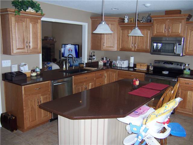 Cherry cabinets with natural finish - Painted island with glaze finish - Raised panel doors - Standard overlay style - Quartz countertops